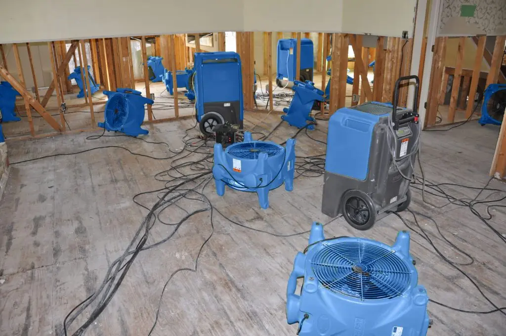 Air movers drying a gutted Denver room after major water damage